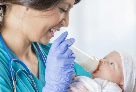 Why Become a Nurse? - A woman holding a baby - Infant