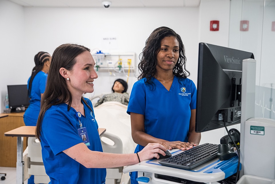 Nursing degree students on campus at nursing college.