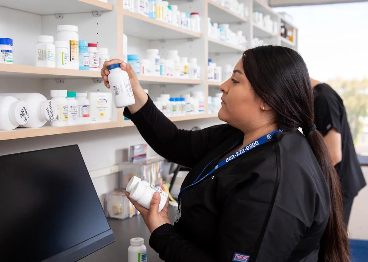 Pharmacy student looking at pills at Arizona College