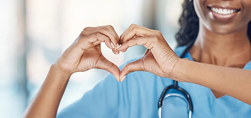 Registered nurse making a heart with her hands at a nursing school near me