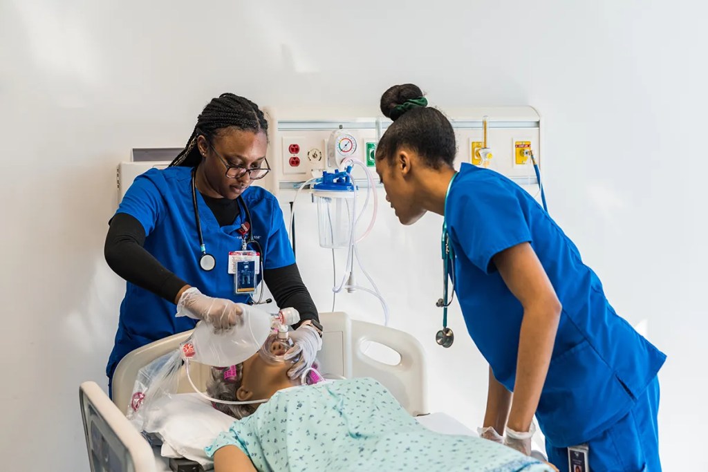 Nursing students learning clinical skills