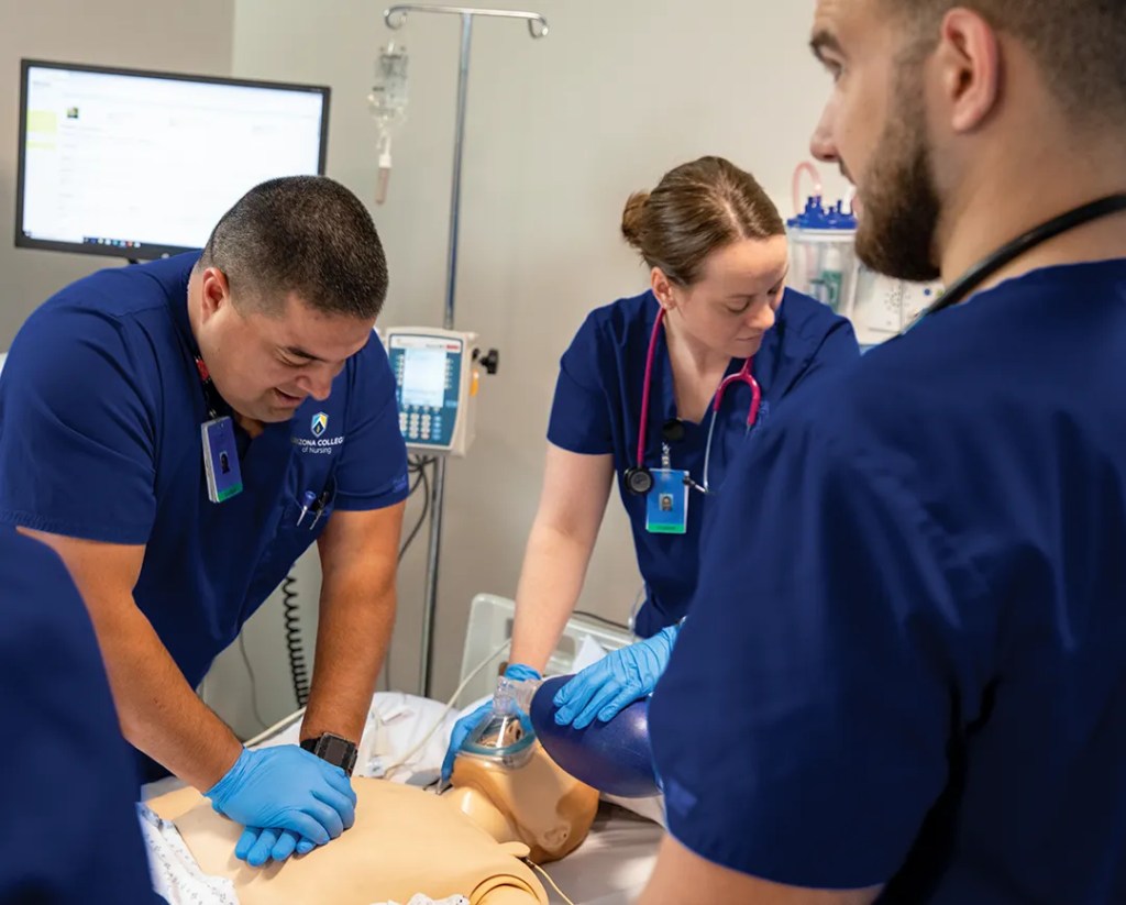 Students using equipment in nursing program